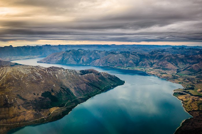 Breathtaking aerial landscape shot of mountains and a river - travel photography jobs